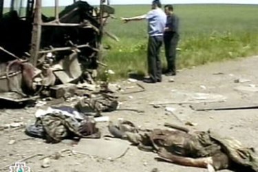 video grab from the Russian television NTV shows the bodies of dead Russian soldiers lying near a destroyed army bus on the border road separating Ingushetia from North Ossetia near Chechnya, 19 June 2003. Three Russian soldiers were killed and seven others injured, when the bus carrying 10 interior ministry soldiers, returning to their base in Vladikavkaz, North Ossetia, ran over the mine near a checkpoint on the border road separating Ingushetia from North Ossetia