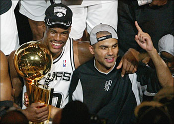 David Robinson (L) of the San Antonio Spurs and Frenchman Tony Parker celebrate after beating the New