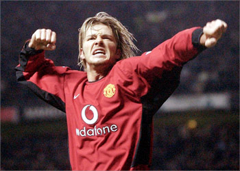 (FILES) Manchester United's David Beckham celebrates after his shot was rebounded into the goal by Ruud van Nistelrooy against Leeds United during their premiereship clash at Old Trafford in Manchester 05 March 2003. Manchester United have conditionally accepted an offer from Spanish club Barcelona for David Beckham, 10 June 2003 though the deal depends on Beckham himself accepting the move and Joan Laporta being elected as Barcelona's president. AFP Photo by Paul Barker