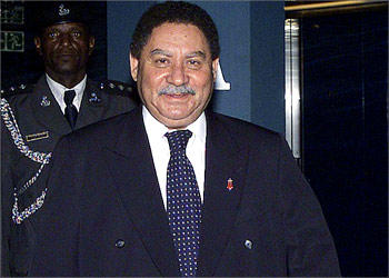 Sao Tome and Principe President Fradique de Menezes smiles as he walks towards reporters in Abuja, Nigeria, on July 16, 2003. Menezes, appealed for help from world leaders to reverse the coup on the twin-island state, which happened when he was in neighboring Nigeria. A storm of international protest gathered over the West African island state on Thursday as neighboring countries, the United States and the United Nations condemned a day-old coup. Troops on the archipelago seized power on Wednesday in a dramatic escalation of bubbling political turmoil on the mountainous archipelago, fanned by arguments over what may be rich oil reserves lying near its shores. REUTERS/George Esiri