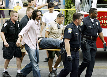 F_A victim is moved to triage after a car careened through a crowded farmers' market 16 July, 2003 in Santa Monica, California. At least eight people were killed, including a 2-year-old girl, and at least 40 people were hurt, 14 critically, when a car driven by a man in his 80s plowed through the market on Arizona Avenue traveling about 60 mph, according to witnesses. ( Doug Benc/Getty Images/AFP) -FOR NEWSPAPER AND TV USE ONLY-
