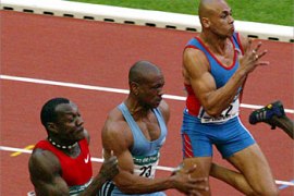 f_US Maurice Greene (C) runs with Nigerian Deji Aliu (L) and Australian Patrick Johnson during the 100m men final during the Golden League athletics meeting at the Stade de France in Saint-Denis, north of Paris, 04 July 2003. Greene finished third behind Aliu and US Bernard Williams. AFP PHOTO JEAN-PIERRE MULLER