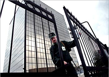 F: Security officer closes Sibintek office's gates in Moscow, 06 August 2003, as investigators search the office. The Russian Prosecutor's Office kept up the pressure on the oil giant Yukos, searching the offices of two of its subsidiaries, including Sibintek, which provides Yukos with computer support.