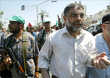 Hamas spokesman Abed al-Aziz al-Rantisi is surrounded by bodyguards as hundreds and thousands of Palestinian mourners take part in the funeral procession of senior Hamas leader Ismail Abu Shanab in Gaza City 22 August 2003. The Palestinian militant groups Islamic Jihad and Hamas issued a joint statement calling off their seven-week-old truce because of an Israeli air strike that killed one of their top leaders Shanab yesterday, and two of his bodyguards. Thousands of Palestinian jammed the streets of Gaza City for the funeral that was likely to turn into an emotional outpouring of grief and rage. Some 20,000 already rallied yesterday. AFP PHOTO/Mahmud HAMS
