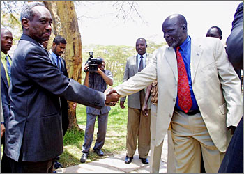 Sudanese vice-president Ali Osman Taha (L) and Sudan Peoples Liberation Army (SPLA) leader John Garang (R) shake hands prior to the signing an agreement on security issues, seen as a key step in reaching a comprehensive accord to end Africa's longest war, 25 September 2003 in the Kenyan town of Naivasha, 90 km west of Nairobi. AFP PHOTO/SIMON MAINA