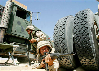 US army 3rd platoon transportation company 740 of the national guard take positions during maneuvers with life ammunition at Udairi rang north of Kuwait City 17 September 2003. The exercise aims at providing the US army with first-hand expertise in protecting the routes of American convoys from ambushes in Iraq. AFP PHOTO/Yasser AL-ZAYYAT