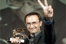 Russian director Andeji Zvjagintsev makes the victory sign as he poses with the Golden Lion awarded for the best film during a prize ceremony of the Venice International Film festival at Venice Lido movie palace 06 September 2003. AFP PHOTO/Vincenzo PINTO