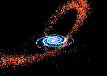 CAPTION CORRECTION: CORRECTING SIZE OF SAGITTARIUS Our Milky Way galaxy (center/blue) is gobbling up its galactic neighbor, Sagittarius, (red trail, from left to right) and on September 24, 2003, scientists offered documentary proof of this continuing cosmic cannibalism. On its way to oblivion, the dwarf Sagittarius -- which is about 10,000 times smaller in mass than the Milky Way -- is getting stretched, torn apart and ultimately eaten, scientists at the University of Virginia and the University of Massachusetts reported. REUTERS/Handout