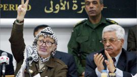 Picture taken 29 April 2003 shows Palestinian leader Yasser Arafat flshing the victory sign after finishing his speech to the Palestinian Legislative Council (parliament), next to Palestinian Prime Minister-desgnate Mahmud Abbas in the West Bank city of Ramallah 29 April 2003. Arafat is still considering prime minister Mahmud Abbas' resignation letter, Arafat's security adviser, Jibril Rajub, told reporters 06 September 2003