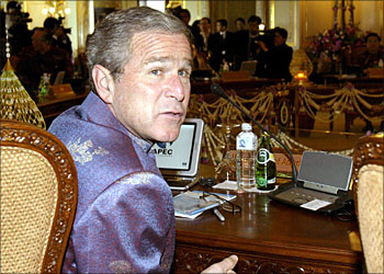 US President George W. Bush speaks with journalists at the start of the "APEC Economic Leaders' Retreat II" meeting at the Ananta Samakhom Throne Hall in Bangkok, 21 October 2003. Leaders from the 21 APEC member economies began their second day of talks 21 October, with the issues of terrorism, North Korea's nuclear crisis and stalled world trade talks high on the agenda