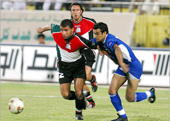 F: Palestenian Player Mohammed Mohammed (L), fights for the ball against Ali al-Shamali of Kuwait during their Group B qualifying match of the Asian football championship in Kuwait
