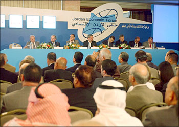 Business men listen on as Bayan Baker Al-Zubeidi (4th L) head of the Iraqi delegation and ministers and others discuss the rebuilding of Iraq 13 October in Amman during a seminar part of the Jordan Economic Forum