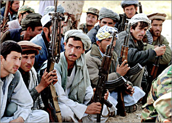 Afghan militia wait to turn in their weapons at a military base in Kunduz, Afghanistan on 22 October, 2003. A long-awaited U.N.-sponsored project to disarm, demobilize and reintegrate 100,000 soldiers across Afghanistan was under way in the north, a key step to bringing eventual peace to this war-torn country. The "New Beginnings Program," which lets soldiers exchange their weapons for jobs, began in the northern province of Kunduz on Monday. AFP PHOTO/Richard VOGEL/POOL