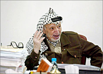 Palestinian leader Yasser Arafat gestures in his office in the West Bank town of Ramallah 26 October 2003. Eighty-five percent of Palestinians are satisfied with veteran leader Yasser Arafat's performance, according to an opinion poll released last week by Bir Zeit University. AFP PHOTO JAMAL ARURI