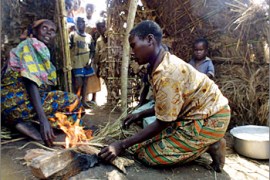 A resident of Mwito village prepares a meal in her home, 15 October 2003, 14 kilometers outside Bunia. The 3,100 displaced living in Mitwo are asking for UN protection and say they are under threat from attacks in the war-torn region.