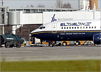 A German border police armoured personnel carrier secures a plane of Israel's national carrier El Al Airlines at Berlin Schoenefeld international airport on November 23, 2003. The airport stopped all flights for an hour after security personnel detained a suspicious person on the flight, German radio reported. REUTERS/Michael Dalder