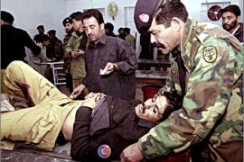 A Pakistani security officer (R) helps his bomb blast injured colleague at a hospital in Quetta late 10 November 2003. At least nine people including five policemen and two journalists were injured when a series of three bomb went off in this Pakistani town, bordering Afghanistan. AFP PHOTO/Banaras KHAN