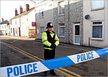 Police tape blocks the entrance to the area of Gloucester, western England, where officers from Britain's anti-terror branch arrested a 24-year-old man and evacuated the surrounding area, November 27, 2003. British police hunting for international terrorists detained two men on Thursday, one of whom is believed to have connections with al Qaeda and whose arrest "could be pretty big" according to a security source. REUTERS/Martin Bennett