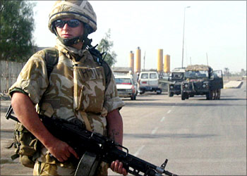 A British soldier stands guard at the site where a British army jeep was hit by an explosion near the medical college hospital in central Basra, south of Baghdad, 09 November 2003. The blast happened when British forces were marking Remembrance Day in the city, which commemorates soldiers killed in action.