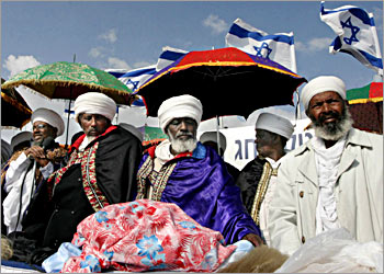 Ethiopian Jewish clergymen "Kessim" use umbrellas to protect themselves from the sun as they pray during the "Sigd" holy day, on a hill overlooking Jerusalem, 24 November 2003. The traditional prayer is performed by Ethiopian Jews every year to celebrate the biblical union between the Jewish people and God. AFP PHOTO/GALI TIBBON