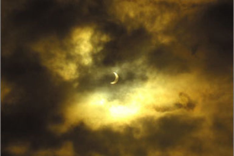 This handout received 24 November 2003 shows the clouds partially obscuring the solar eclipse over the Australian Antarctic base of Davis.