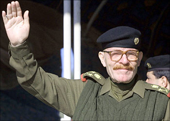 File photo dated 07 January 2003 shows Saddam Hussein's deputy, the vice president of the former ruling Revolutionary Command Council (RCC), Izzat Ibrahim, saluting members of Iraq's "Army of Jerusalem" during a military parade in the northeastern town of Diala, about 50kms from the capital Baghdad. A member of the US-installed Iraqi Governing Council told the Qatar-based Al-Jazeera satellite channel 02 December 2003 that a "major figure" from Saddam Hussein's former regime had been "killed or captured" in the northern Iraqi Kirkuk region. Number six on the US wartime list of most wanted Iraqi officials, Ibrahim is the highest-ranking official of the former regime still at large, apart from the ousted president himself, and has a 10-million-dollar bounty on his head.
