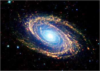 Image shows multiwavelength composite of Messier 81, a nearby galaxy located in the constellation Ursa Major, one of the first images from the Spitzer Telescope released by NASA on December 18, 2003. The new Spitzer, which looks at the cosmos with infrared detectors, has lifted the dust veils from newborn stars and a bumptious comet, and revealed the detail in the spiral arms of a neighboring galazy. Unlike the Hubble Space Telescope, which takes pictures of the universe from high in Earth orbit, Spitzer makes its observations as it trails behind Earth as our planet circles the sun. REUTERS/NASA/Handout