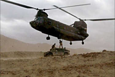 r - A U.S. CH-47 Chinook helicopter prepares to sling load a damaged Humvee vehicle in Afghanistan's Paktika province as part of