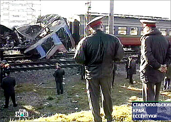 F_Russian NTV channel shows two policemen look at the wreckage of a commuter train destroyed by a suicide bomber in the town of Yessentuki, southern Russia, 05 December 2003. At least 35 people died and 75 were injured when a blast blamed on a suicide bomber ripped through a Russian commuter train near the war-torn republic of Chechnya Friday, two days before a national parliamentary election. AFP PHOTO / NTV