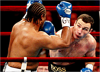 Vitali Klitschko from Ukraine connects with a right to the jaw of Canadian Kirk Johnson during the first round of their WBC Heavyweight elimination fight at New York's Madison Square Garden, December 6, 2003. Klitschko won with a technical knockout in the second round. REUTERS/Jeff Zelevansky