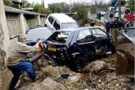 A resident of la Barasse district in Marseille salvages a chair amid damaged cars, December 3, 2003. Devastating floods have claimed five lives and forced more than 10,000 people to evacuate their homes. Road, rail and air traffic was disrupted by incessant rain and high winds, and four nuclear power reactors shut down as flooding along the Rhone River and its tributaries between Lyon and Marseille turned the region into a disaster area. REUTERS/Philippe Laurenson