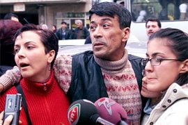 r: Turkish engineer Hasan Onal is flanked by his wife Miray and daughters Idil Ceren (partially seen) and Merve Deniz (R) on his arrival home in western Turkey's coastal city of Izmir