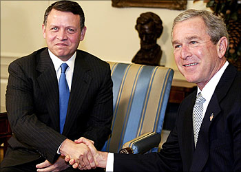 US President George W. Bush (R) greets Jordan's King Abdullah II (L) in the Oval Office of the White House 04 December, 2003, in Washington, DC. Bush and the King are expected to discuss the Mideast peace road map and the current situation in Iraq. The Jordanian monarch is on a private visit to Washington but has brought new ideas from Palestinian Prime Minister Ahmed Qorei on how to relaunch efforts to end the Palestinian-Israeli conflict