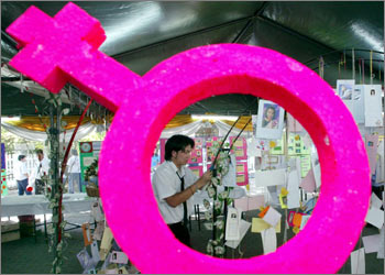 A student decorates postcards to support AIDS patient during AIDS exhibition at Red Cross in Bangkok