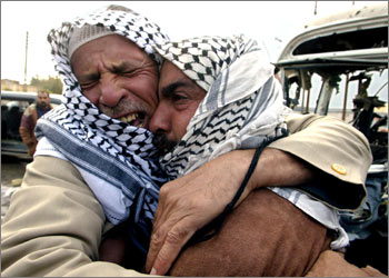 Two unidentified Iraqi men mourn following a US army attack in the town of Samaraa,