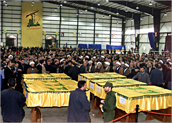 Militants of Lebanese Shiite movement Hezbollah carry the coffins of fighters killed during the Israeli occupation, in the predominantly Shiite Muslim southern suburbs of Beirut 31 January 2004. The Red Cross handed over 30 January 2004 to the Lebanese authorities and Hezbollah militia the bodies of 59 anti-Israeli guerrillas, mostly Lebanese, after their return by Israel. The return of the bodies was part of a broader agreement under which Israel freed 400 Palestinians and 31 other prisoners, 23 of them Lebanese, in exchange for a captured Israeli businessman and the bodies of three Israeli soldiers killed in October 2000. AFP PHOTO/Haitahm MUSSAWI