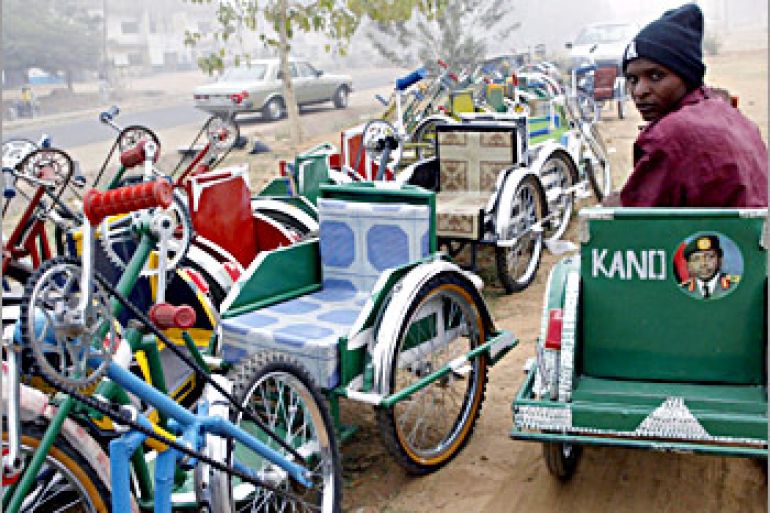 Eighteen-year-old Abdullahi Idris, who suffers from polio, drives his hand-powered tricycle past dozens for sale 08 January 2004 in the northern city of Kano, where opposition from Islamic leaders has derailed a drive by the World Health Organisation to eradicate the crippling disease through mass child immunisation. Some radical clerics claim that the vaccine has been adulterated with anti-fertility agents, an allegation health experts fiercely deny. AFP PHOTO/PIUS UTOMI EKPEI