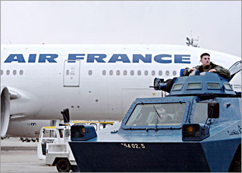 A light armoured vehicle patrols in front of an Air France plane leaving for New-York during visit of French Interior Minister Nicolas Sarkozy at Roissy-Charles-De-Gaulle airport where he has been evaluating the security measures. Air France resumed its flights to Los Angeles on December 26 but US authorities remain watchful. The Washington Post reported that two Air France flights had been escorted into Los Angeles by US F-16 fighter jets 30 and 31 December -- a report indirectly confirmed by French junior transport minister Dominique Bussereau. France had cancelled six Air France flights between Paris and Los Angeles on Christmas Eve after US investigators wrongly identified six passengers as potential terrorists, according to French officials. AFP PHOTO THOMAS COEX