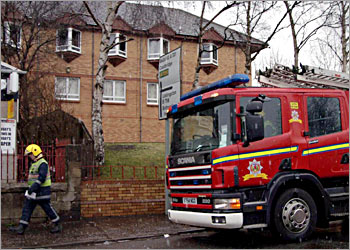 A fire engine is parked in front of Rose Park care home after a huge fire swept through a retirement home early 31 January 2004, in Uddingston near Glasgow. At least 11 people were killed in the balze, firefighters said and the toll could still rise further, as seven people were injured, two of them critically. AFP PHOTO/IAN STEWART