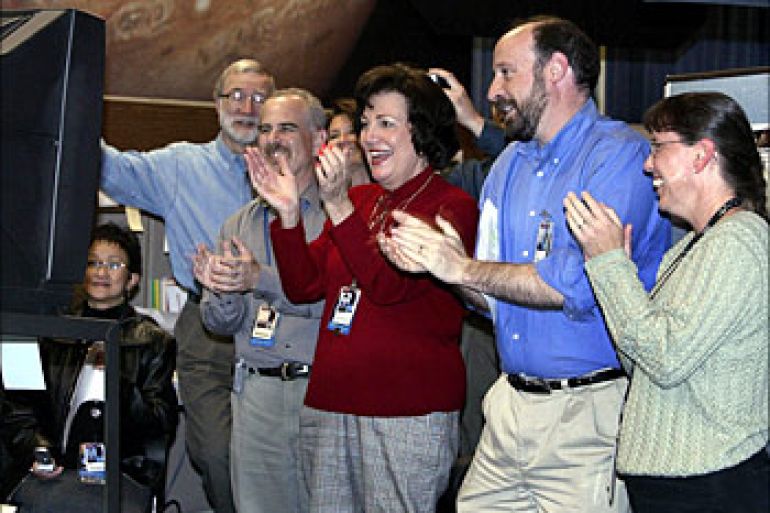 Jet Propulsion Laboratory (JPL) engineer Randii Wesson (2R) and other JPL employees react as the second Mars rover "Opportunity" lands on Mars, 24 January 2004 at NASA's Jet Propulsion Laboratory (JPL) in Pasadena, California.