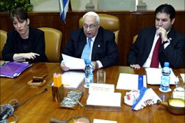 Israeli Prime Ariel Sharon (C), opens his weekly cabinet meeting as Education Minister Limor Livnat (L), and Cabinet Secretary Yisrael Maimon (R), look on at the start of the meeing in Sharon's Jerusalem office 18 January 2004. Israel's top-level security cabinet was to begin discussions on changing the contentious route of a West Bank barrier to try to make it more defensible in an Israeli and an international court, senior government officials said.