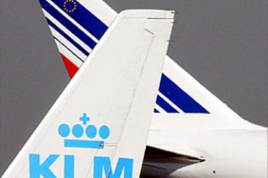 This file photo taken 30 September 2003 at Roissy Charles de Gaulle airport shows the tales of a KLM and an Air France aircrafts. The European Commission was set 11 February 2004 to approve a planned merger between Air France and KLM Royal Dutch Airlines, creating the world's biggest airline in terms of sales, EU sources said.
