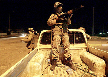 Iraqi Civil Defense Corps (ICDC) members, who were trained by US military personnel from the 4th Infantry Division Ironhorse, secure an area during a joint night patrol with US soldiers in Tikrit, the former stronghold of ousted leader Saddam Hussein in northern Baghdad, 28 February 2004. Marathon talks on Iraqs temporary constitution failed to produce a deal as the countrys leaders appeared unable to mend their rifts on womens rights, federalism and Islamic law. AFP PHOTO/DANIEL MIHAILESCU