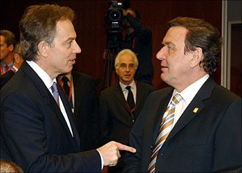 afp - British Prime Minister Tony Blair (L) chats with German Chancellor Gerhard Schroeder upon their arrival at the European Summit in Brussels, 25 March 2004. European leaders trumpeted Thursday tough new measures to combat terrorism after the Madrid train blasts, as they opened a summit clouded by the Al-Qaeda spectre thrown up by the bombings.