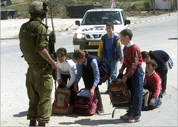 f: Palestinian school children open their school bags to show an Israeli soldier, as they make their way home into the center of the West Bank town of Hebron after school,