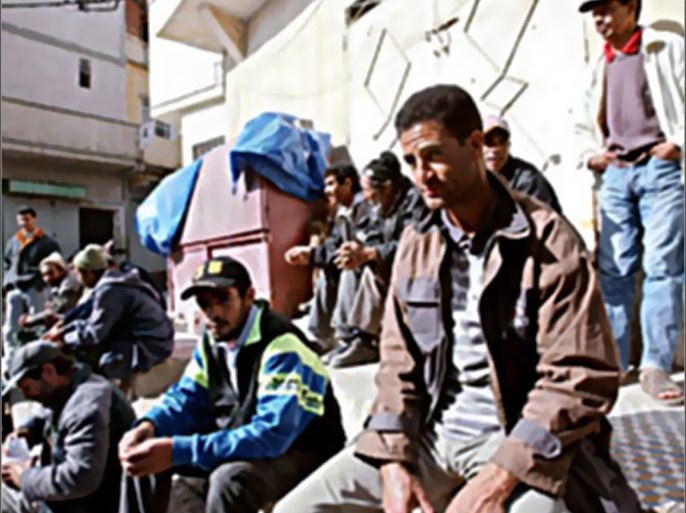 f / Unemployed workers wait for job 20 March 2004 in Tangiers's Bani Makada quarter, a popular Islamic fundamentalist