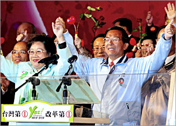 Taiwans President Chen Shui-bian (R) and Vice President Annette Lu (L) raise their arms in victory at the Democratic Progressive Party (DPP) headquarters in Taipei, 20 March 2004. Following the announcing of his victory in the presidential election, Chen promised a new era of cross-strait peace with China and urged Chinese authorities to accept the islands presidential election result. AFP PHOTO/Yoshikazu TSUNO