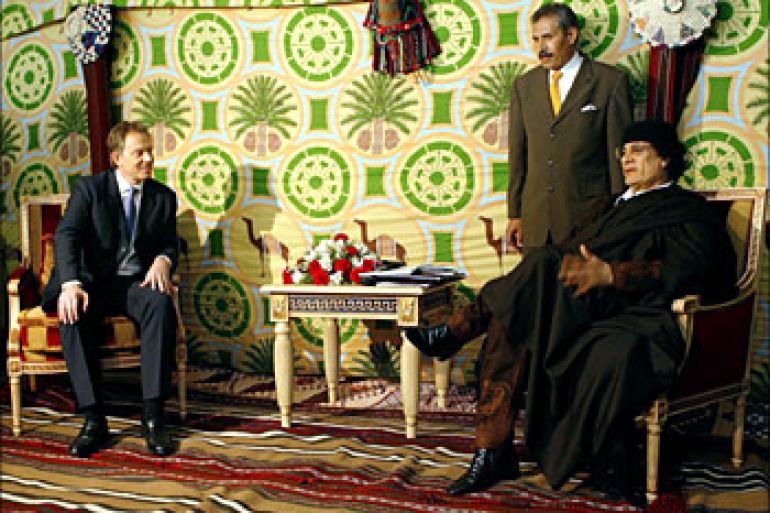 f/ British Prime Minister Tony Blair (L) looks listens to Libyan leader