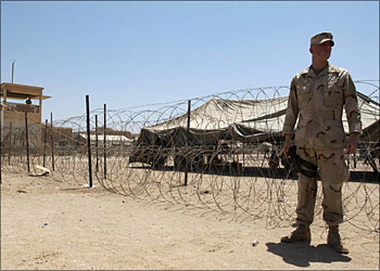 afp - (FILES) -- File picture dated 04 August 2003 shows a US soldier guarding his position at the Abu Gharib prison, west of Baghdad. Twenty-two prisoners were killed and nearly 100 were injured when 12 mortar rounds slammed into the detention facility 20 April 2004, US military officials said. Brigadier General Mark Kimmitt, the US-led coalition's deputy director of military operations, told a press conference the rounds hit the Baghdad Confinement Facility administered by the coalition at Abu Gharib, 20 kilometers (12 miles) west of the Iraqi capital. Ninety-two people were injured and 25 of the most badly hurt were taken away by helicopter, some to the fortified green zone in the center of Baghdad for treatment, a spokesman for the US-led coalition said. AFP PHOTO/Stan HONDA