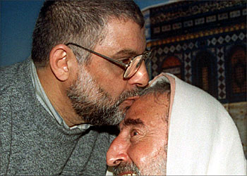 F_File picture dated 07 February 2000 shows Islamic Resistance Movement Hamas leader Abdelaziz al-Rantissi (L) kissing late Hamas spiritual leader Sheikh Ahmed Yassin after Rantissi's release from a Palestinian jail in Gaza City. Al-Rantissi died 17 April 2004 of his injuries from an Israeli air strike in Gaza City. Palestinian sources said the Hamas leader's car took a direct hit from at least two rockets fired by an Israeli helicopter, killing his son Mohammad and two of his bodyguards on the spot. AFP PHOTO/FILES/FAYEZ NURELDINE